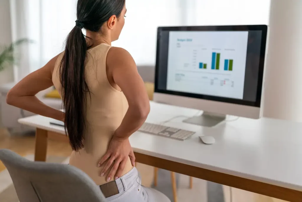 ¿Qué es la artrosis y cómo prevenir de forma efectiva? - que es la artrosis Persona con mala postura sentada en una oficina